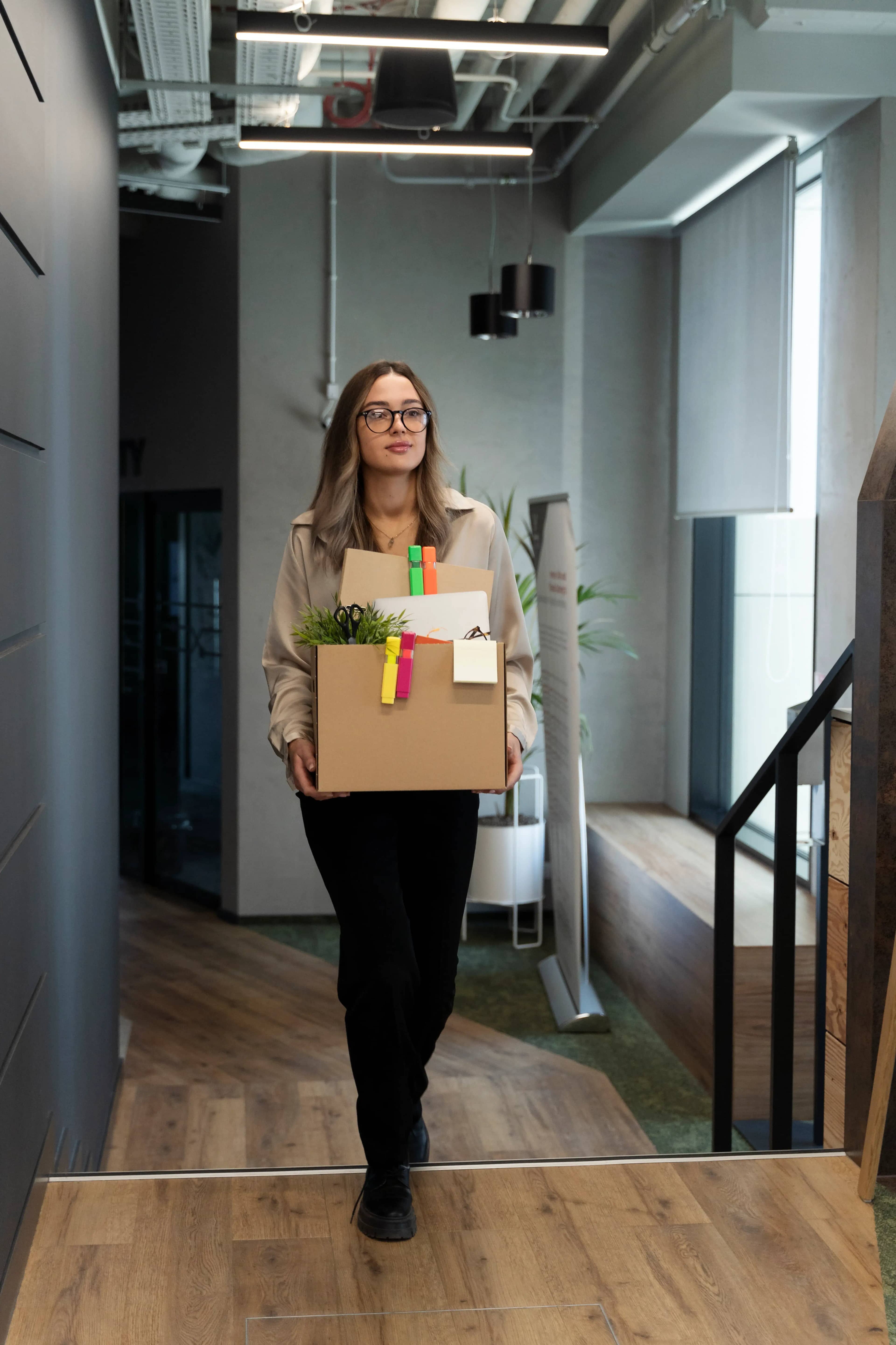 full shot woman holding cardboard box